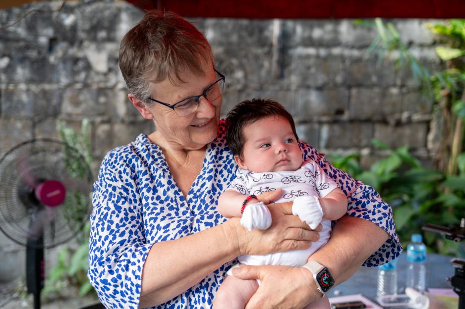Margaret Simons, 65, holding 2-month-old Theo Raymundo.