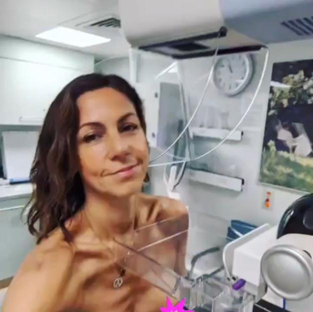 Julia Bradbury posing in a hospital gown while undergoing breast cancer screening.