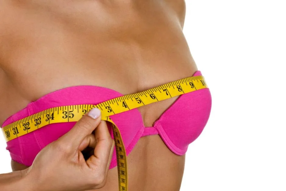 Woman measuring her breast