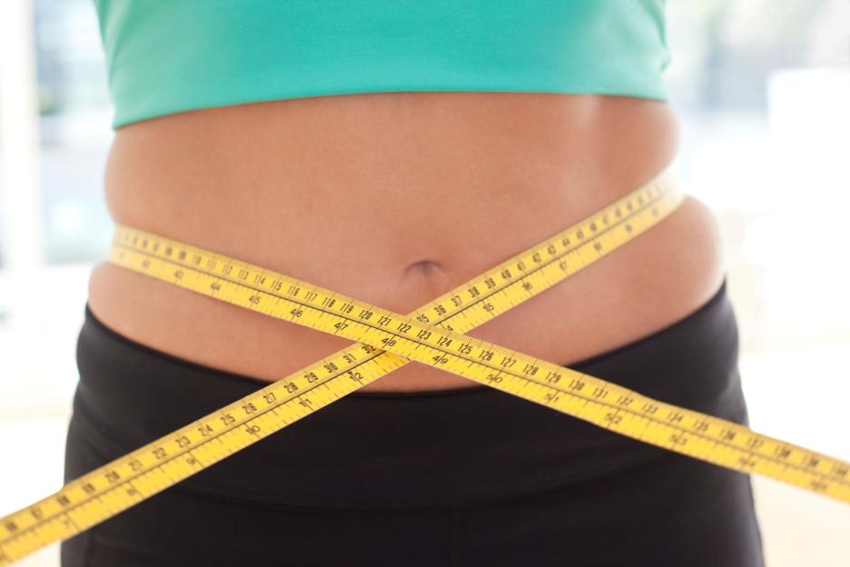 A woman in blue underwear sits on a white chair