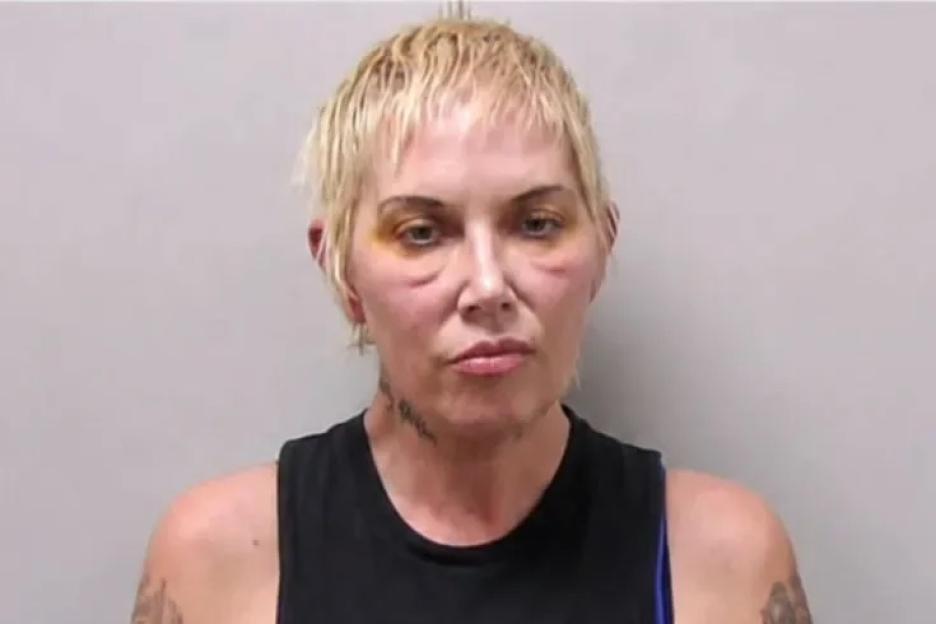 Mugshot of Kim Mathers with visible bruising around her eyes.
