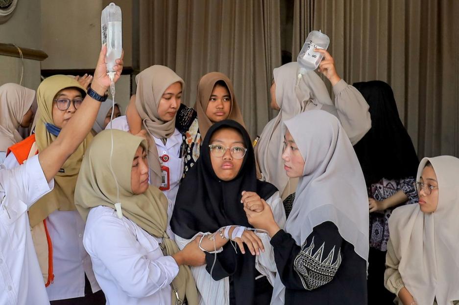 Students receiving IV drips after suspected food poisoning.