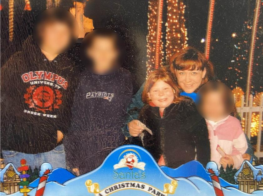 Machelle Hobson and her daughter Jordyn pose for a photo with other children in front of Christmas lights.