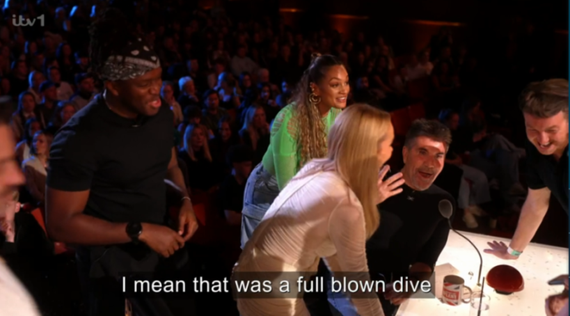 Four judges and a performer at a talent show excitedly leap towards the golden buzzer.