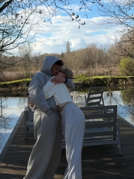 Luca Bish and Grace Jackson embracing on a dock.