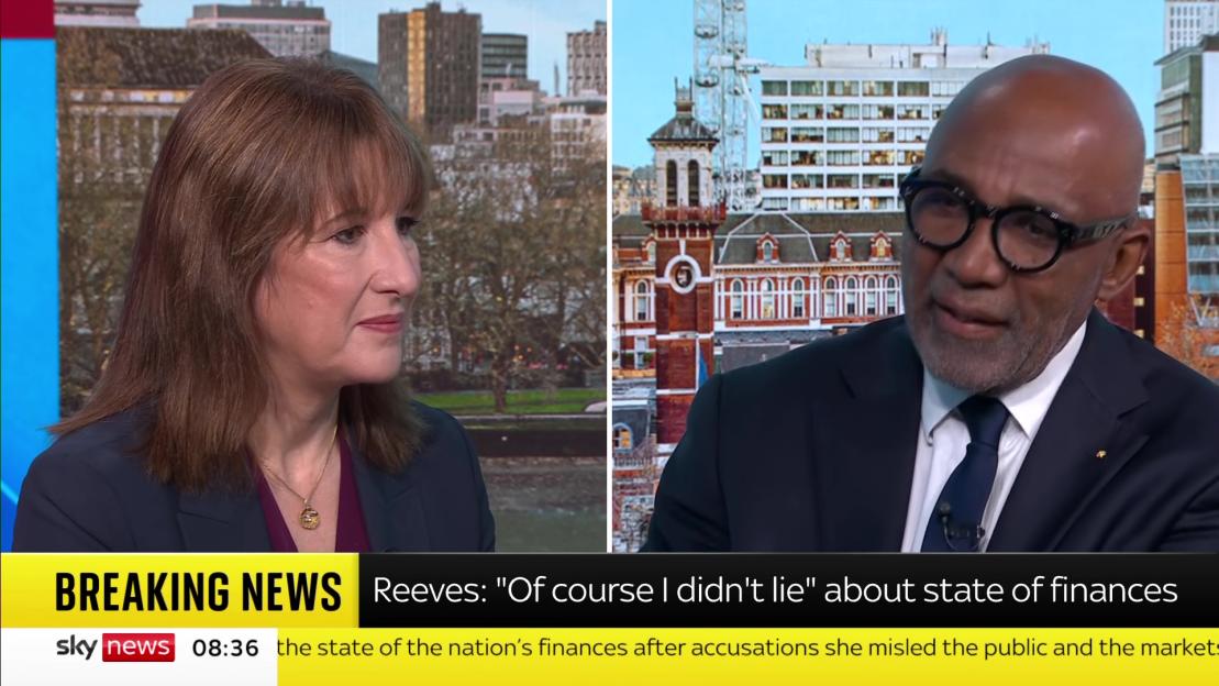 News broadcast with two individuals and text overlay "Reeves: 'Of course I didn't lie' about state of finances".