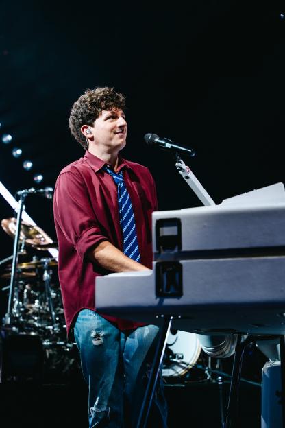 Charlie Puth playing keyboard at a sold-out show in London.