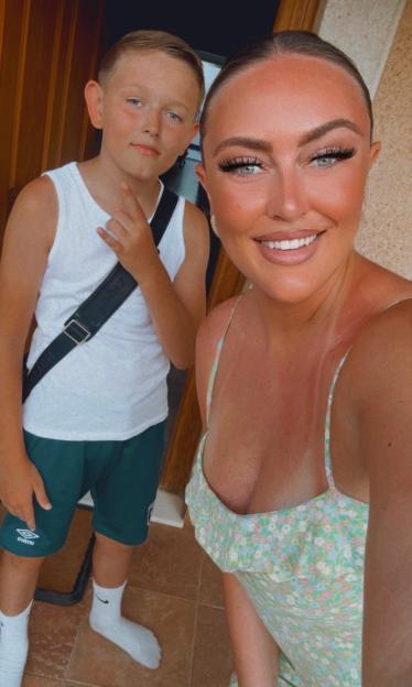 A young boy and a woman posing for a photo.