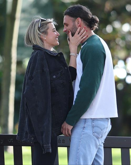 Holly Valance and Grant Gale share a kiss outdoors.