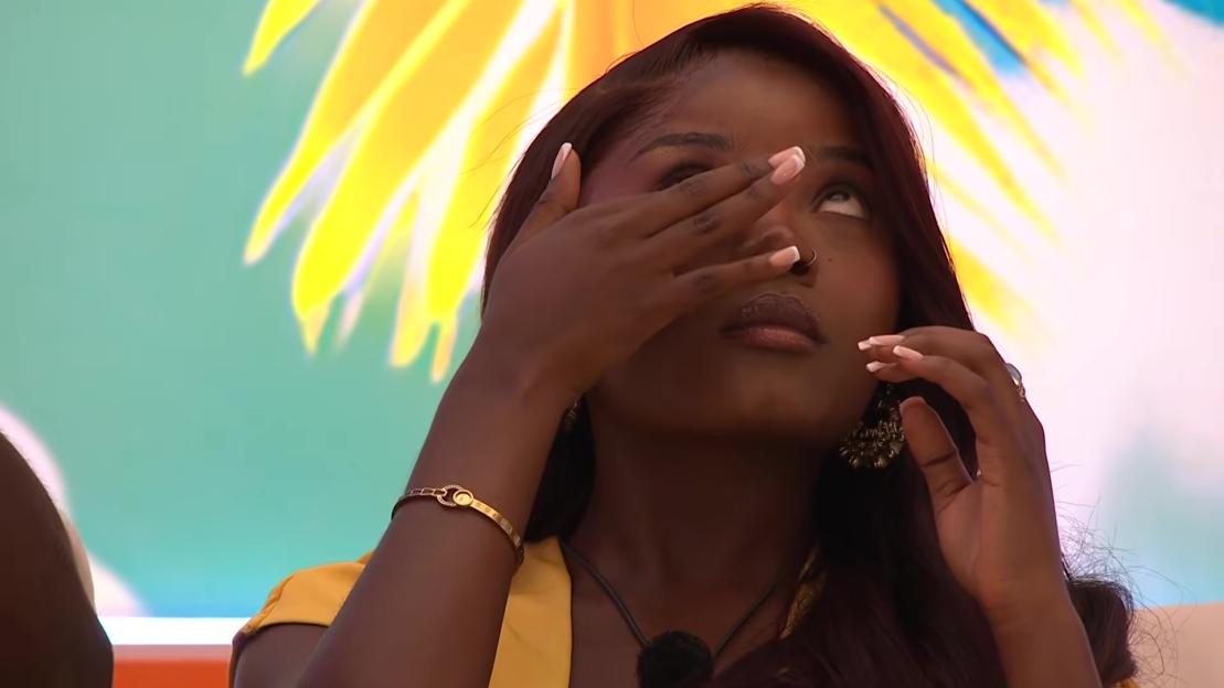 Angelista from Love Island crying, with her hand covering her eyes.