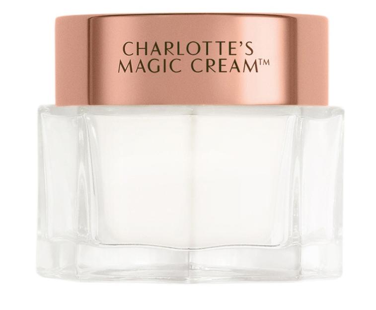 Charlotte's Magic Cream moisturizer in a clear glass jar with a rose gold lid.