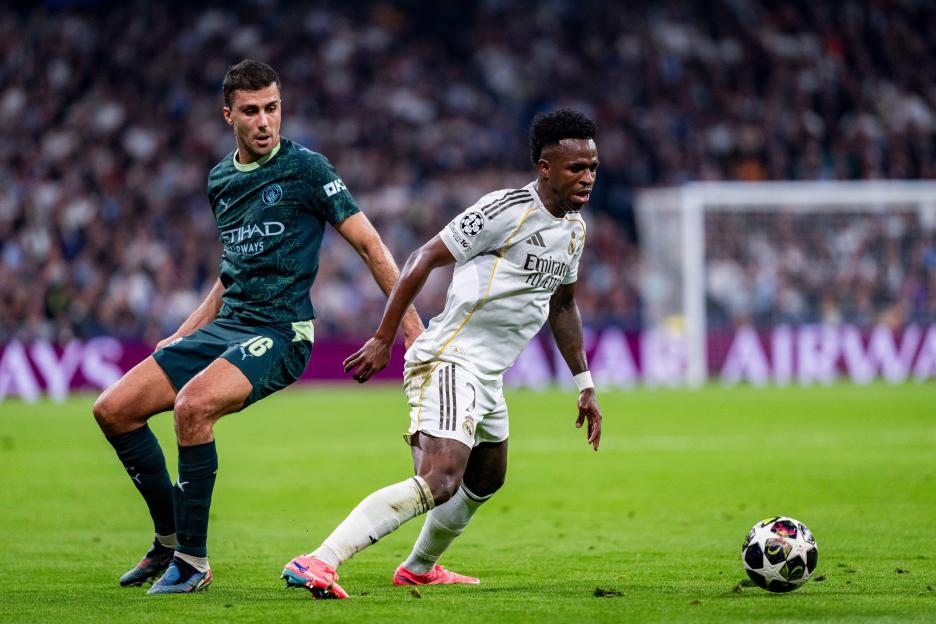 March 11, 2026, Madrid, Madrid, Spain: Vinicius Junior of Real Madrid (R) is in action with the ball defended by Rodri of Manchester City (L) during the UEFA Champions League 2025/26 Round of 16 First Leg match between Real Madrid CF and Manchester C