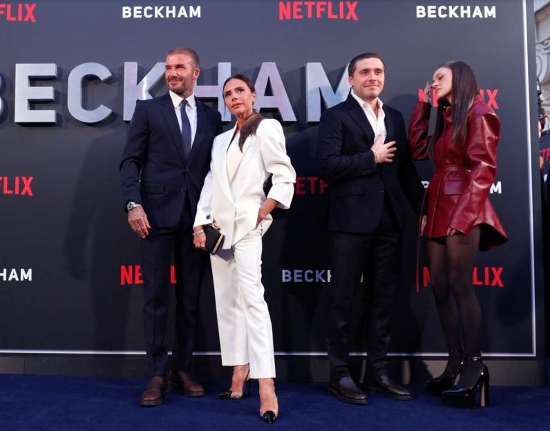 David and Victoria Beckham with Brooklyn and Nicola Peltz-Beckham at an event.