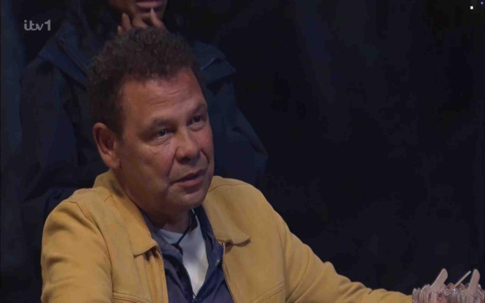 Craig Charles in a yellow jacket.