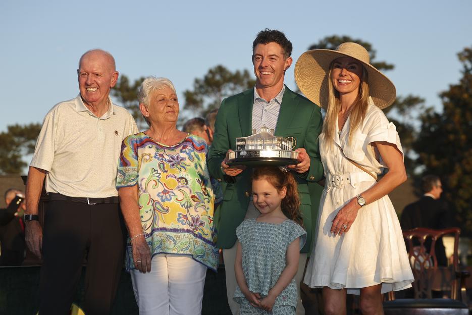 Rory McIlroy poses with his Masters trophy alongside his father Gerry, mother Rosie, wife Erica, and daughter Poppy.