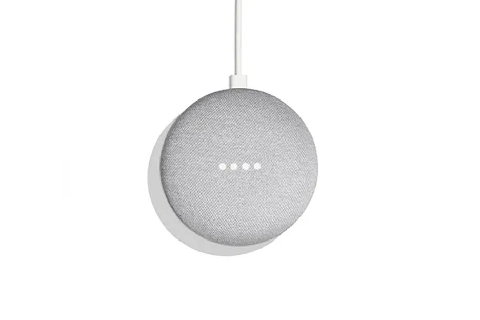 Google Nest Mini smart speaker with a light gray fabric top and four white indicator lights.
