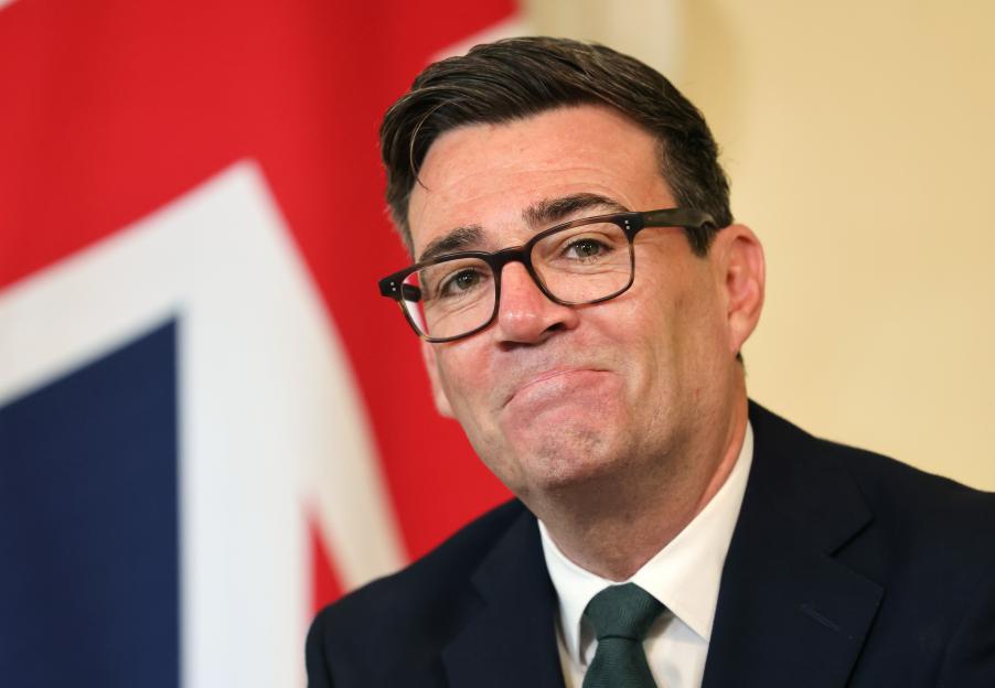 British Prime Minister Andy Burnham reacts during a meeting.
