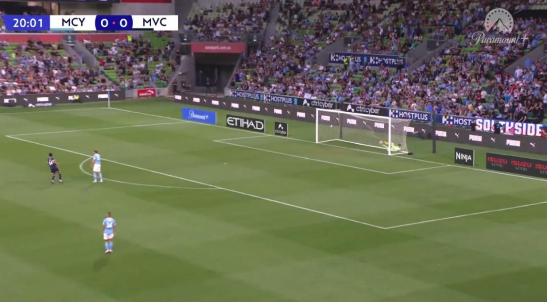 A goalkeeper dives to save a penalty kick during a football match between MCY and MVC.