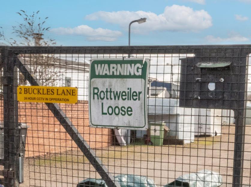 A warning sign on a gated entrance to a traveler site at Buckles Lane.