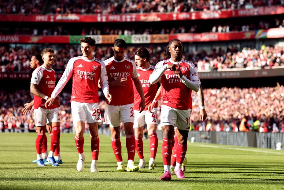Eberechi Eze celebrating his goal with Arsenal teammates during a football match.