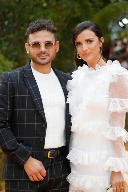 Ryan Thomas and Lucy Mecklenburgh pose on the red carpet at "The Lion King" European Premiere.
