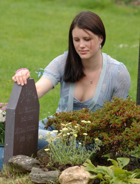 Josie Russell at the graveside of Lin and Megan Russell.