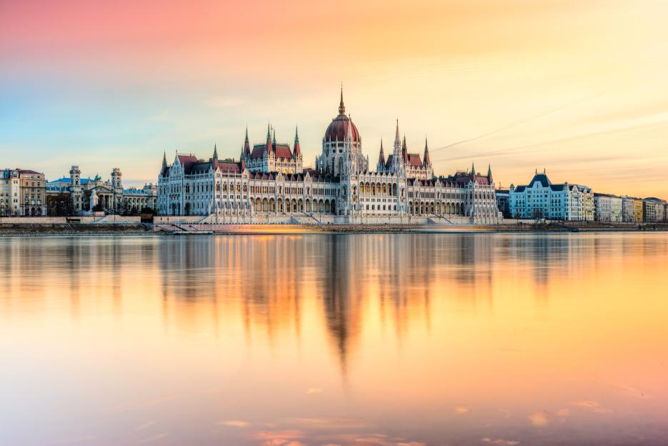 The Hungarian Parliament Building at sunset, reflected in the Danube River.