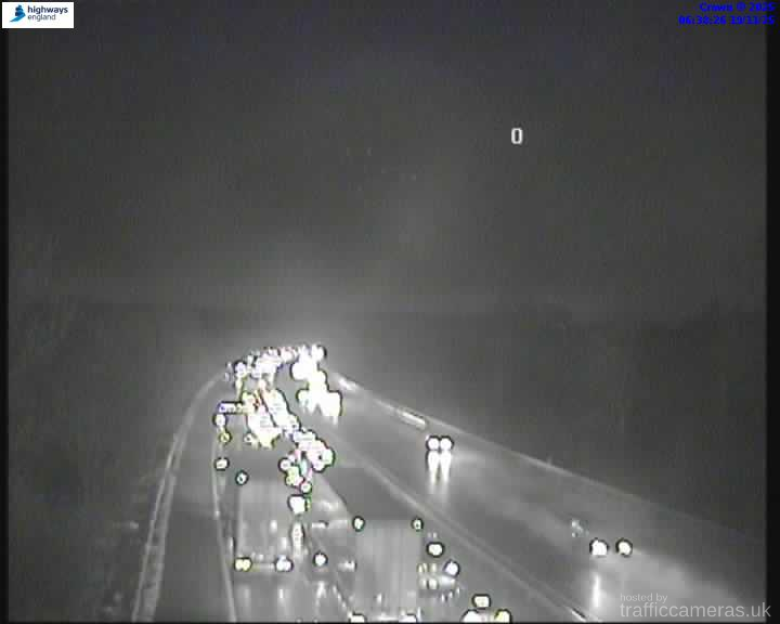 Night vision image of a busy highway with cars, indicating rush hour traffic and potential oil spillage on the M4 in Berkshire.