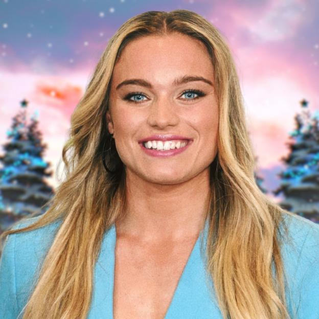 Jodie Ounsley as Gladiator Fury in a blue jacket with a festive background.