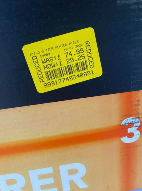 A yellow reduced price sticker on a box for a Pifco 3 Tier Heated Airer, showing the original price of £74.99 and the new price of £29.25.