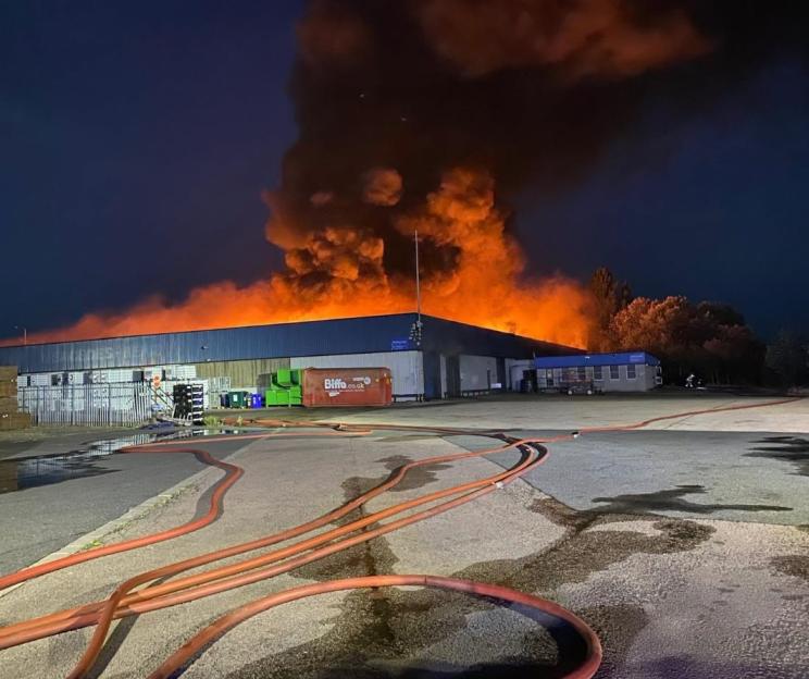 Massive Warehouse Inferno Ignites as Ash Rains Down, Smoke Visible from 30 Miles Away