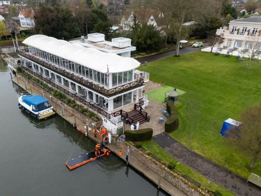 Police search and forensic investigators on the River Thames at a private members club in Henley-on-Thames.