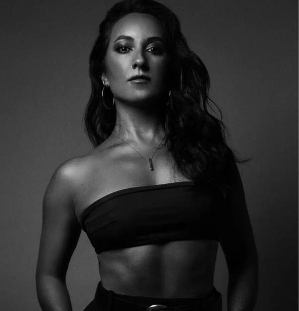 a black and white photo of a woman in a crop top