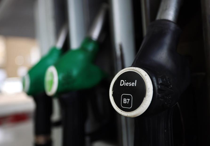 A close-up of a black diesel pump nozzle with "Diesel B7" written on it.