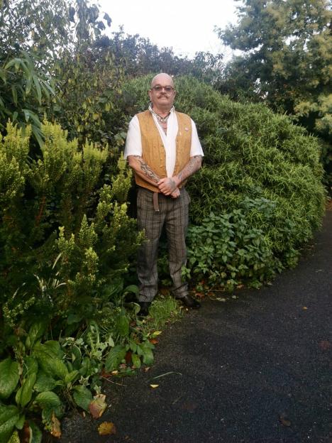 Jim Gardner standing in his award-winning "secret garden."