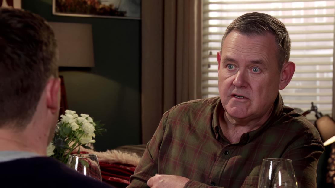 George Shutteleworth talking to another person across a table.