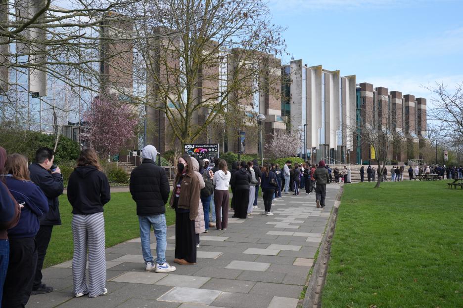 Students queuing for antibiotics outside a building at the University of Kent.