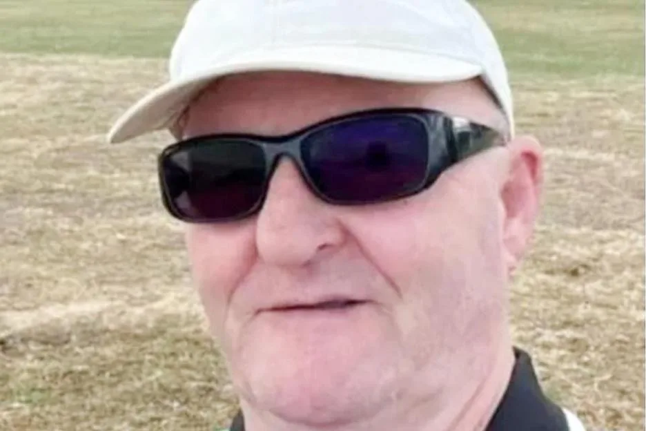 A man wearing sunglasses and a white cap.