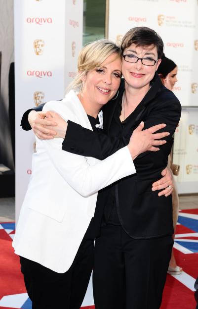 Mel Giedroyc (left) and Sue Perkins hugging at an event.