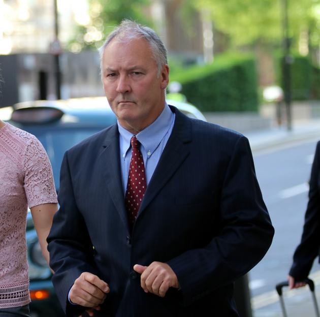 A man in a suit and tie walking outdoors.