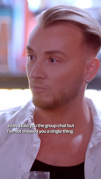 A man with blonde hair and a beard, wearing a white shirt, speaks with the caption "Yeah, I told you the group chat but I've not showed you a single thing."