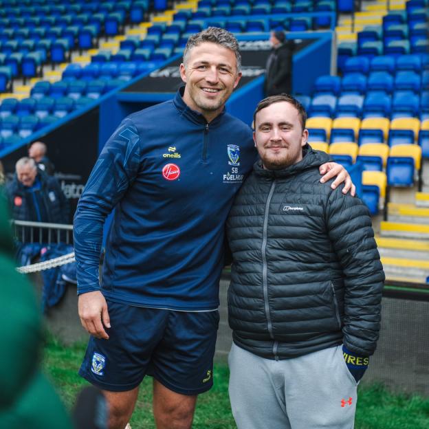 Sam Burgess with a fan in the stadium.