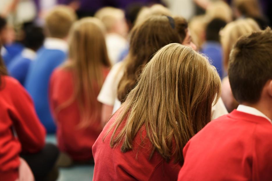 Group of School Children sitting in Assembly in a UK Primary School