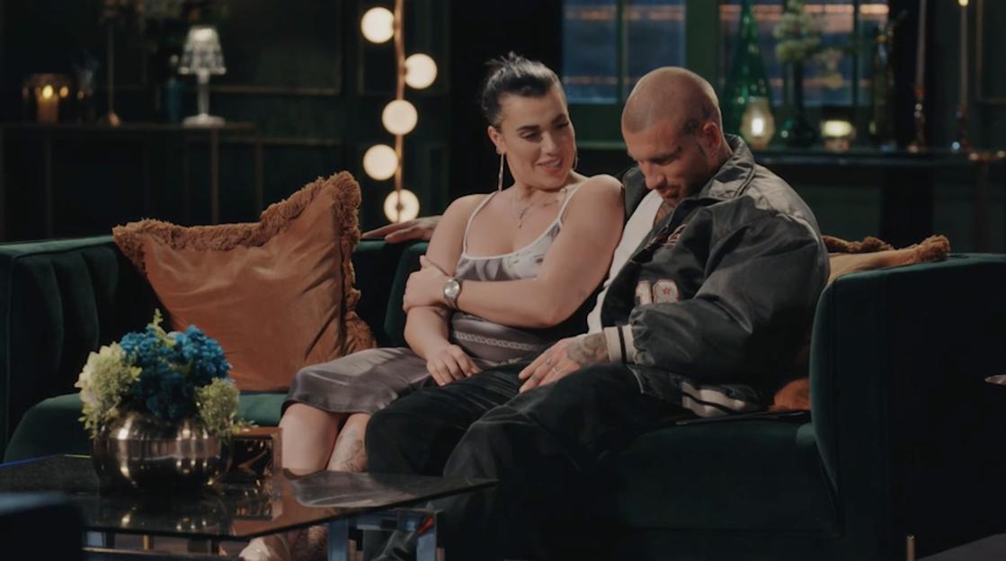 Joe and Maeve sitting on a green couch.