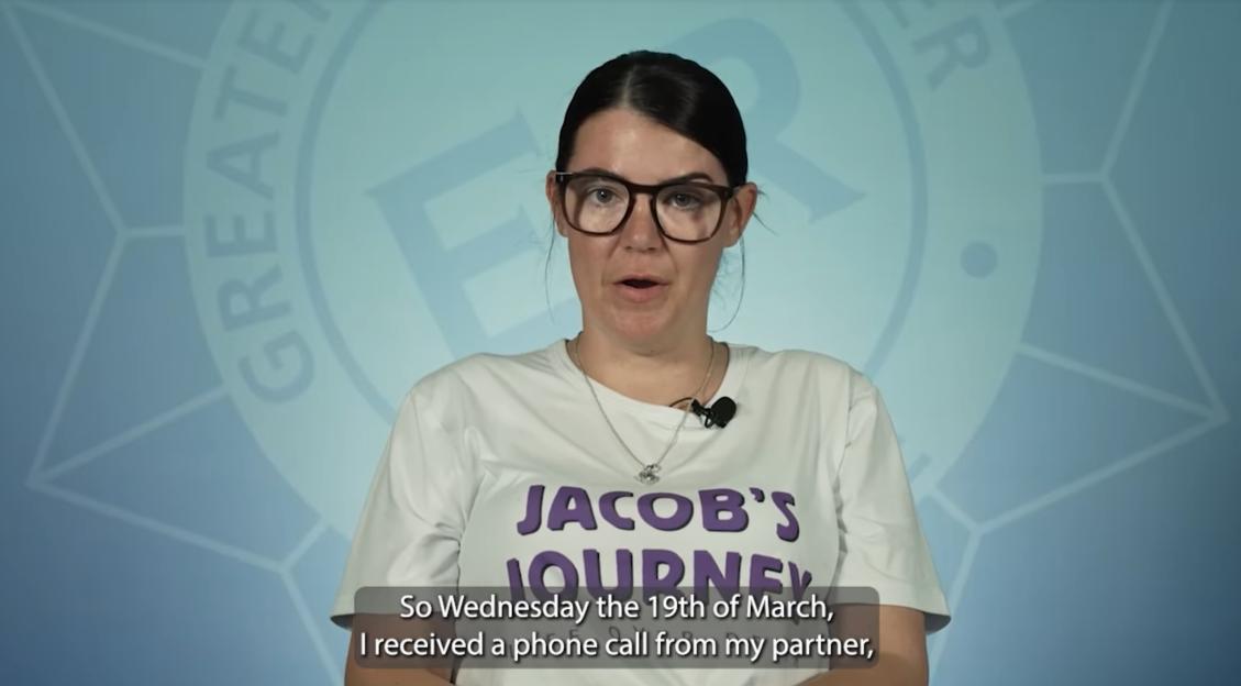 A woman wearing a "Jacob's Journey" t-shirt speaking.