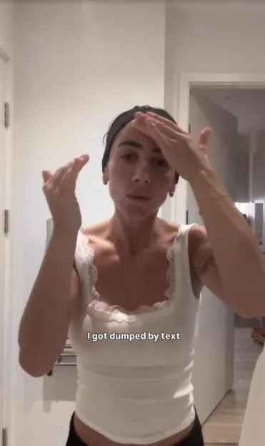 Sammy Harper applying skincare while wearing a white tank top with the caption "I got dumped by text".