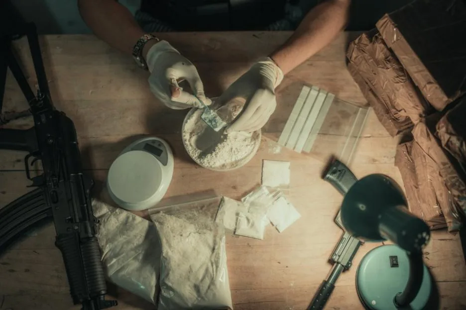 Close-Up Scene of Drug Packaging with Equipment on a Wooden Table