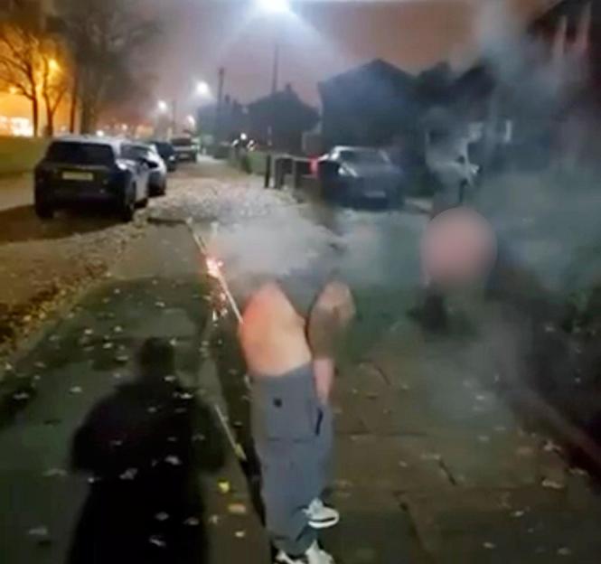 Man with his pants around his ankles attempting to launch a firework from between his buttocks.