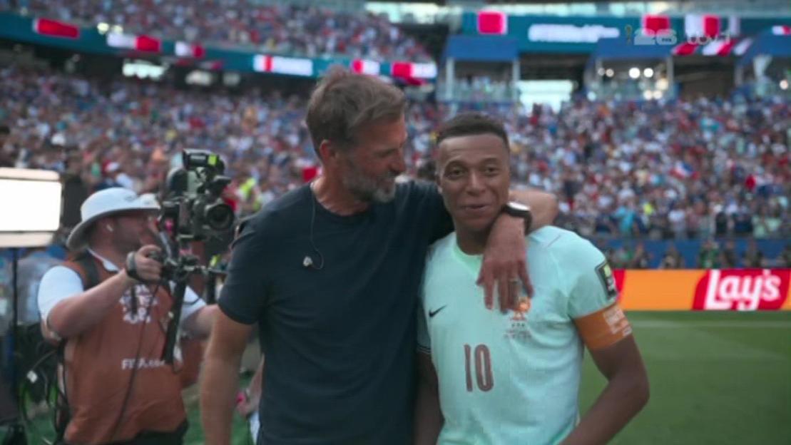 Jürgen Klopp and Kylian Mbappé on a soccer field.