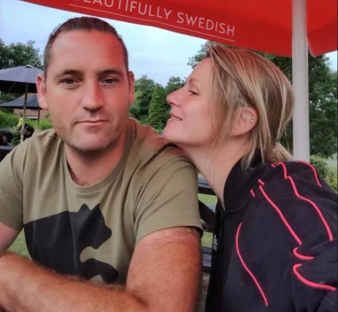Nicky and John Preston under a red umbrella with Rekorderlig Cider branding.